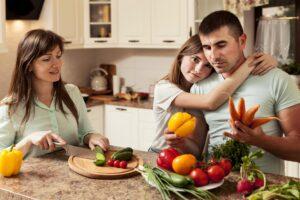 family in kitchen preparing food so they dont get adrenal fatigue