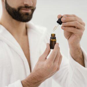 male with a bottle of teatree oil for application to penile yeast infection